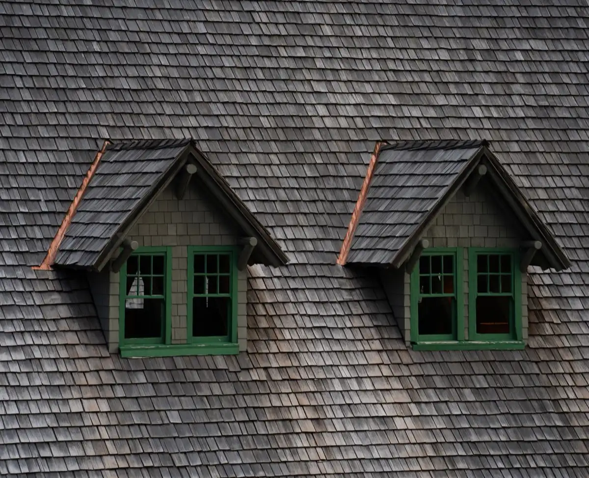 Dormers on a shingle roof in Rome, GA, where step flashing and kickout flashing carry water past the walls